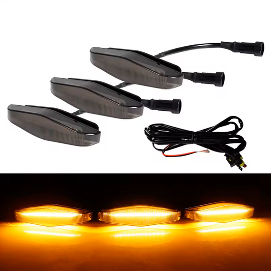 Set of smoked lens amber yellow Raptor lights with wiring on a white background.