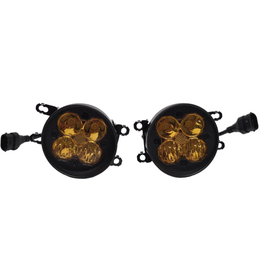 A pair of round black automotive signal lights with amber lenses, shown on a light gray studio background.