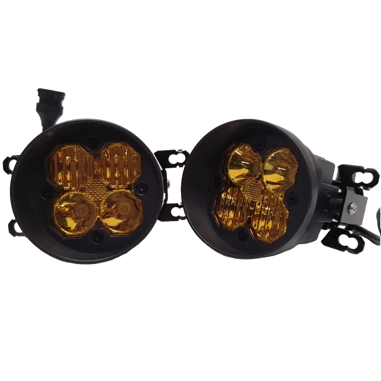 A pair of black circular auxiliary vehicle lights with amber yellow lenses, shown on a plain white studio background.