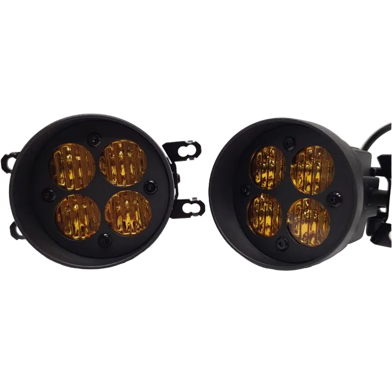Two circular black LED light units with four amber-tinted lenses each, shown on a plain light background.