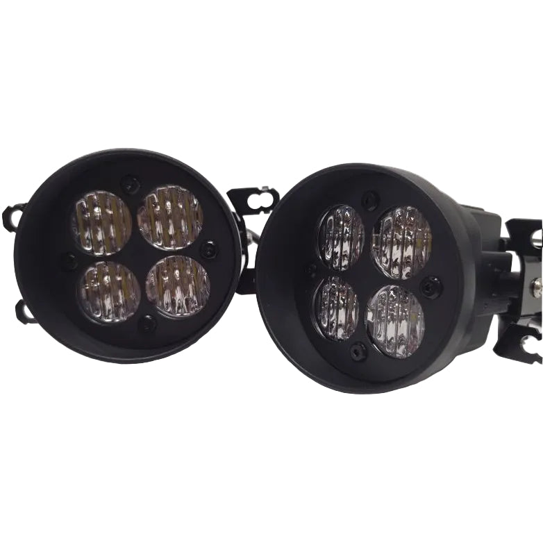 Two black circular LED work lights with four clear lenses each, shown on a plain light gray background.